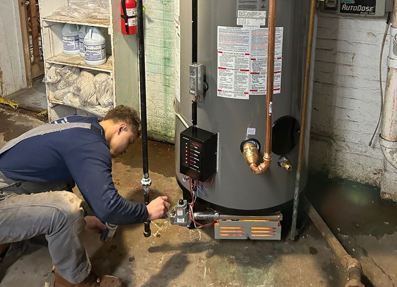 L&A technician servicing a residential water heater